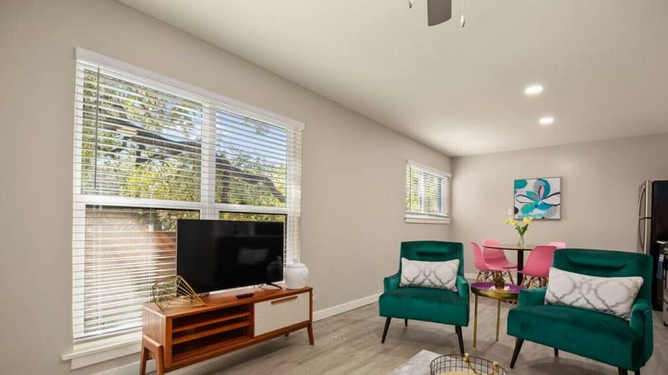 Open concept living room and kitchen with sleeper sofa and smart TV