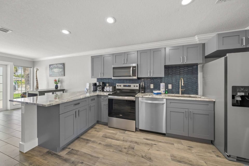 Bright, modern, and fully equipped—this open-concept kitchen is perfect for gatherings.