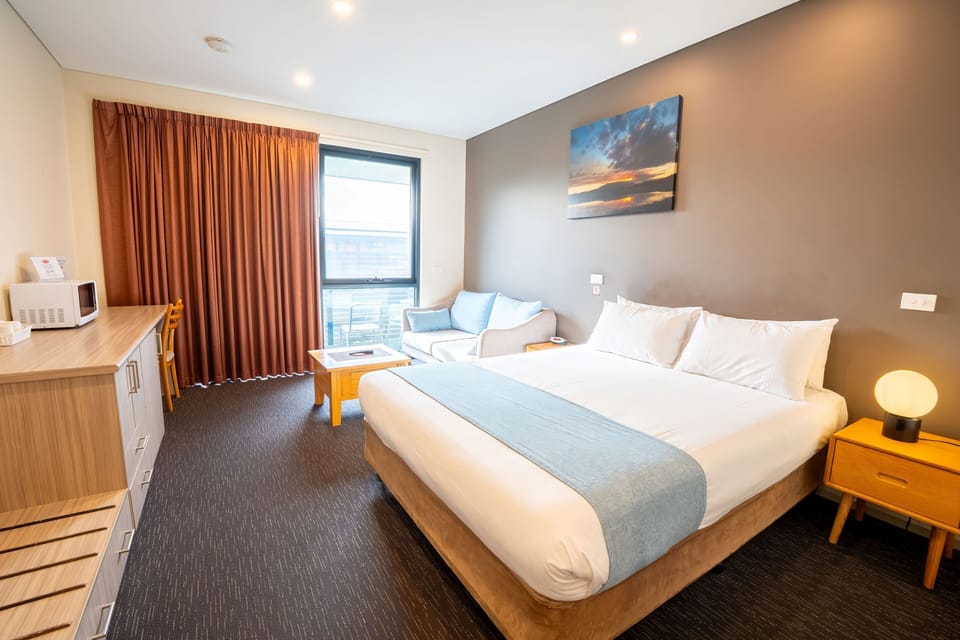 Superior Queen Suite | Desk, laptop workspace, blackout drapes, iron/ironing board