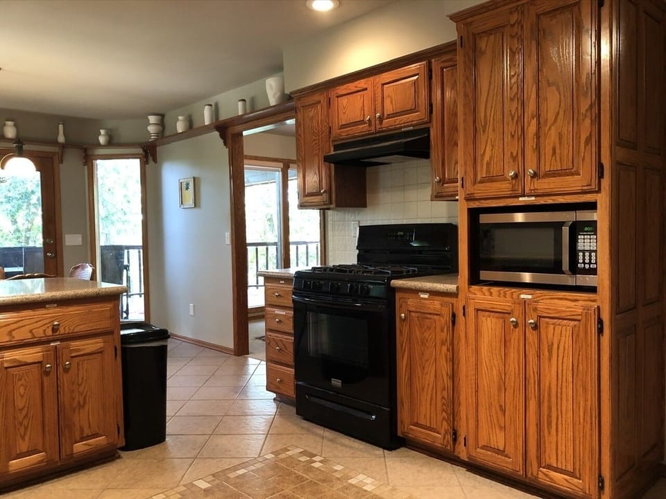 Another angle of kitchen, looking toward dining areas  and deck outside
