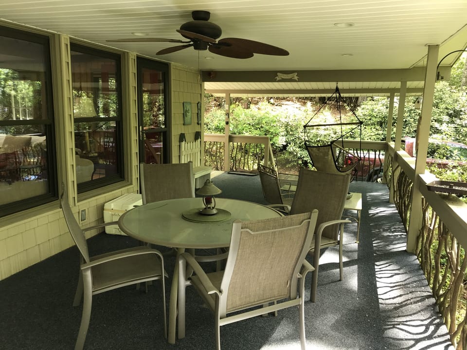 Covered porch with view of game trail and multiple bird feeders.