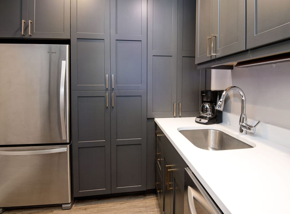 Washer and Dryer a located in the cabinet between the refrigerator and the sink.