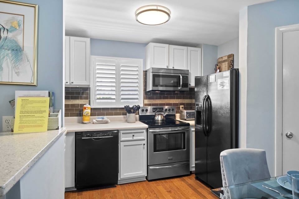 Kitchen with full size fridge, dishwasher, stove and microwave