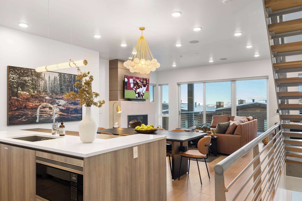 Bright and modern open-concept living space with mountain views – perfect for relaxing after a day on the slopes!