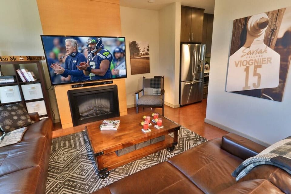 Living room with TV and fireplace located on the 2nd floor