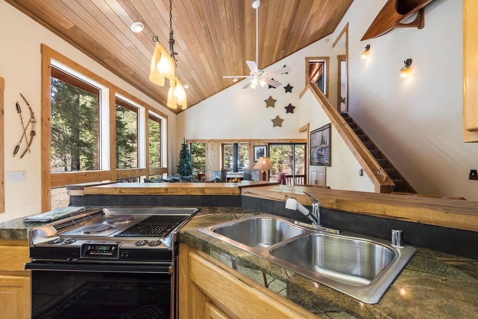 Kitchen with electric stove, indoor grill, dishwasher, oven, and more.