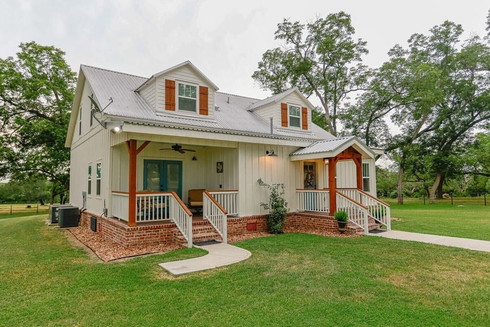 New railing and cozy front porch for coffee or wine sipping.