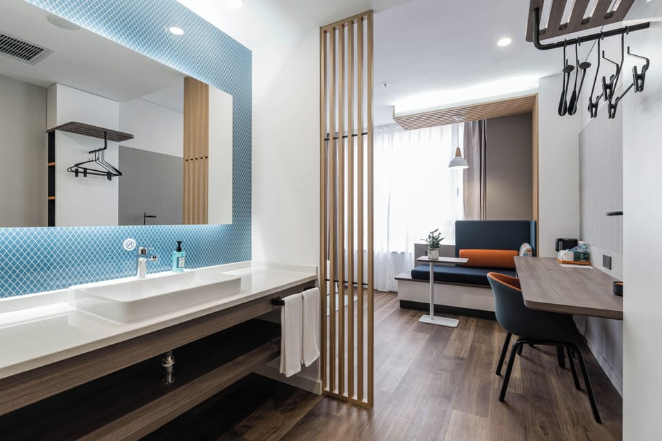 Suite, 1 King Bed | Bathroom | Shower, rainfall showerhead, hair dryer, slippers