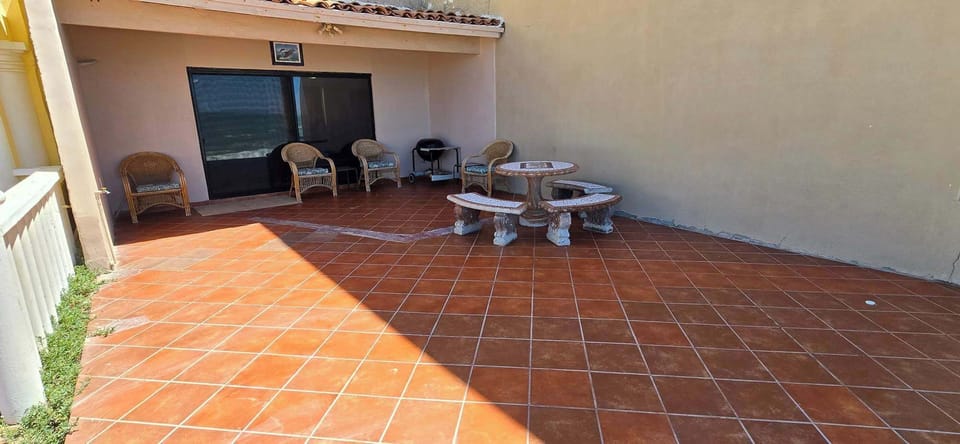 Covered Patio with charcoal grill and seating area
