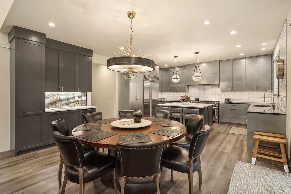 Dining Table with seating for 8 plus 2 more with extra stools in kitchen.