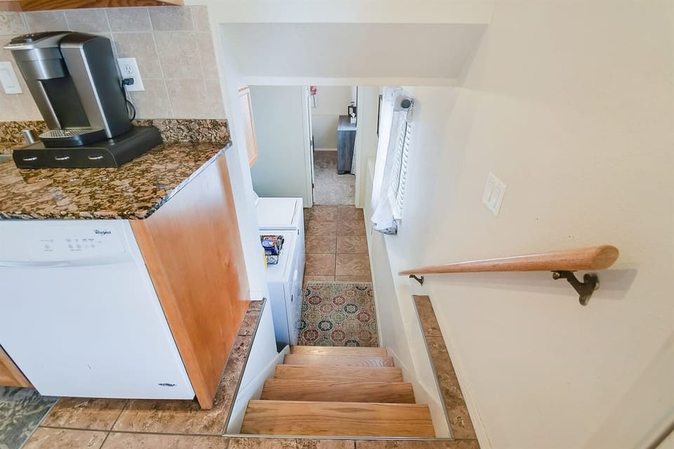 Stairs from main level (second floor) to the downstairs utility room area