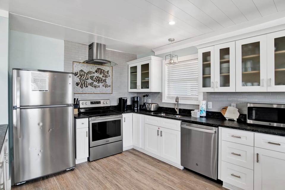 The kitchen is fully equipped and offers stone counters and stainless appliances