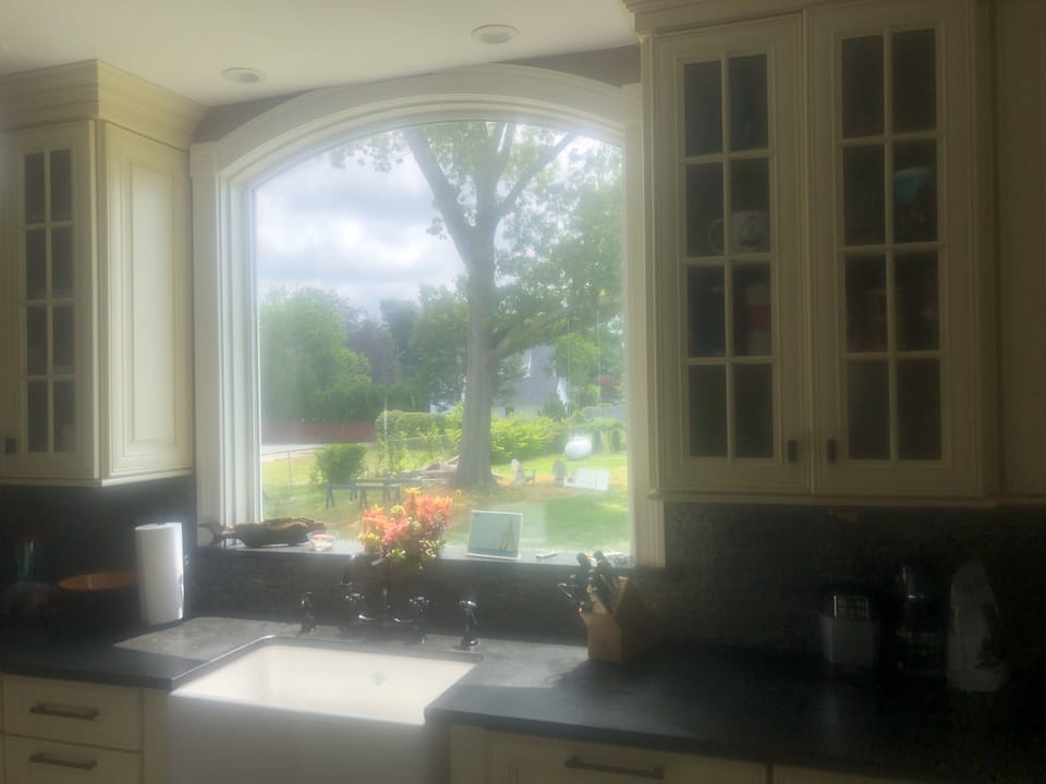 kitchen farm house sink with view of back yard
