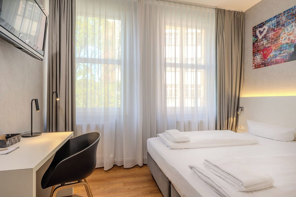 King Room | Premium bedding, desk, blackout drapes, iron/ironing board