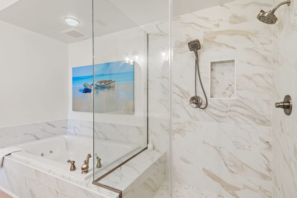 Primary Bathroom - The newly remodeled ensuite boasts sleek, contemporary finishes, a walk-in shower, and a design that perfectly balances beauty and function.