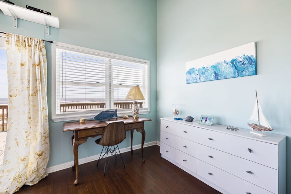 Writing desk in master bedroom with scenic ocean view for inspiring backdrop.