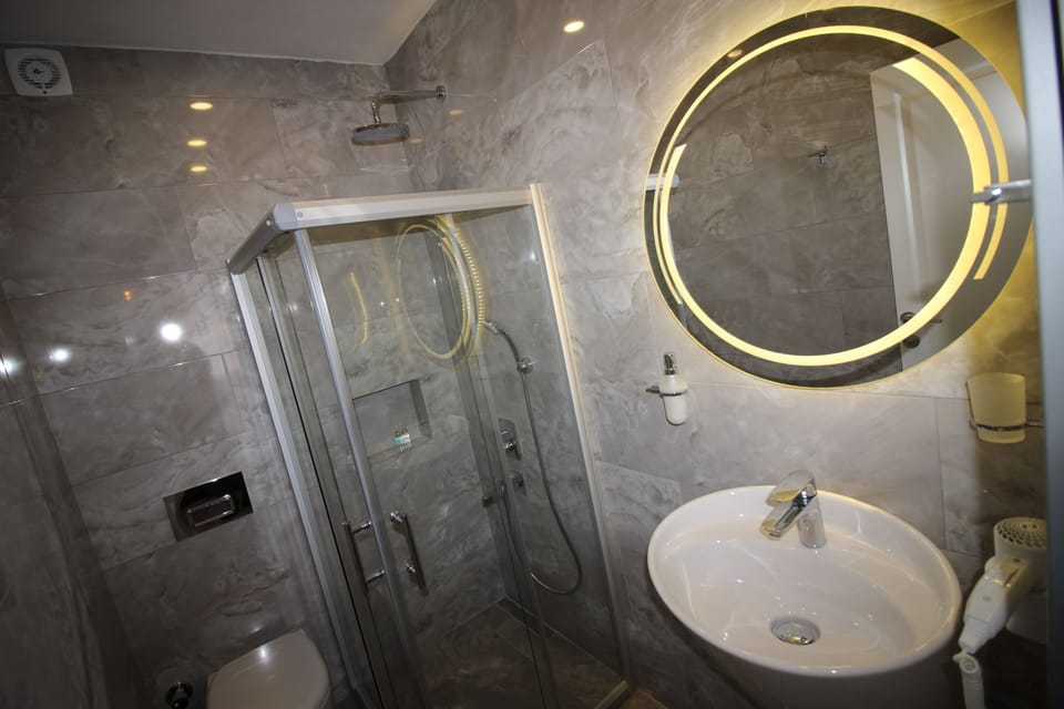 Shower, hair dryer, towels, toilet paper