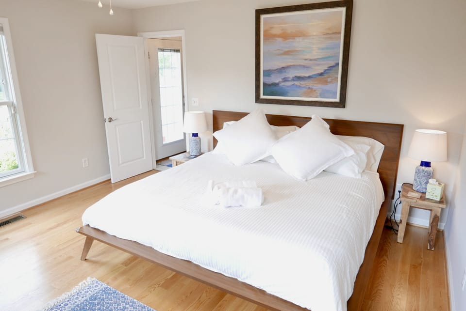 Primary bedroom on ground floor with King sized bed and private bathroom