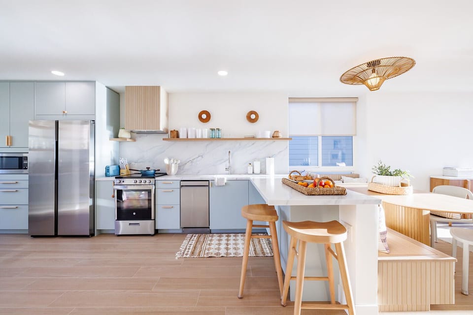 A beautifully updated kitchen showcasing custom cabinetry and custom countertops.