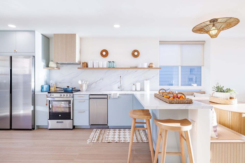 A beautifully updated kitchen featuring custom cabinetry and countertops