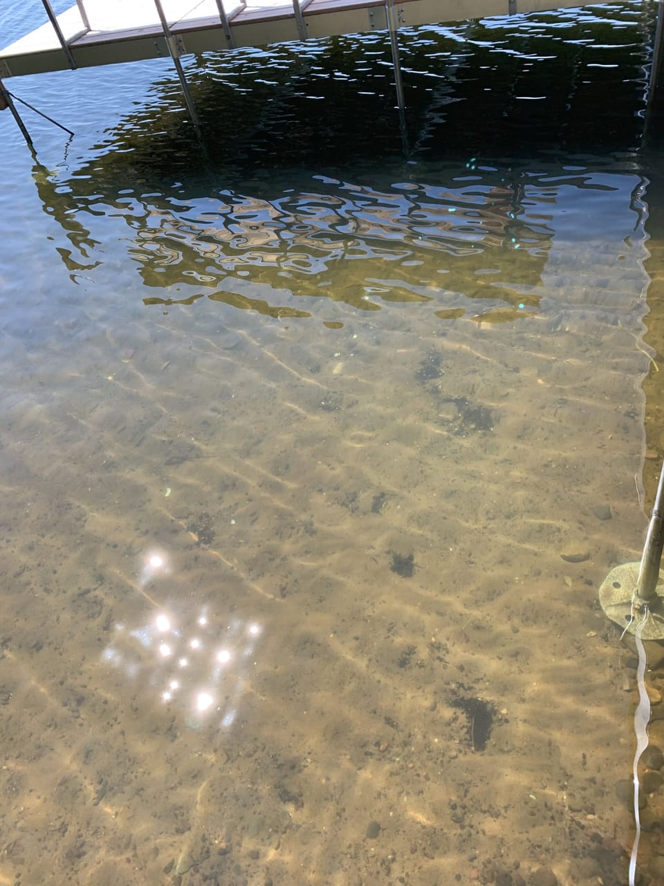 Sandy lake bottom by dock stairs. (2)