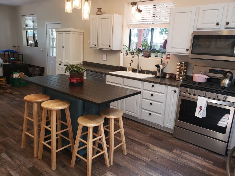 Gourmet kitchen with a gas stove and island bar.