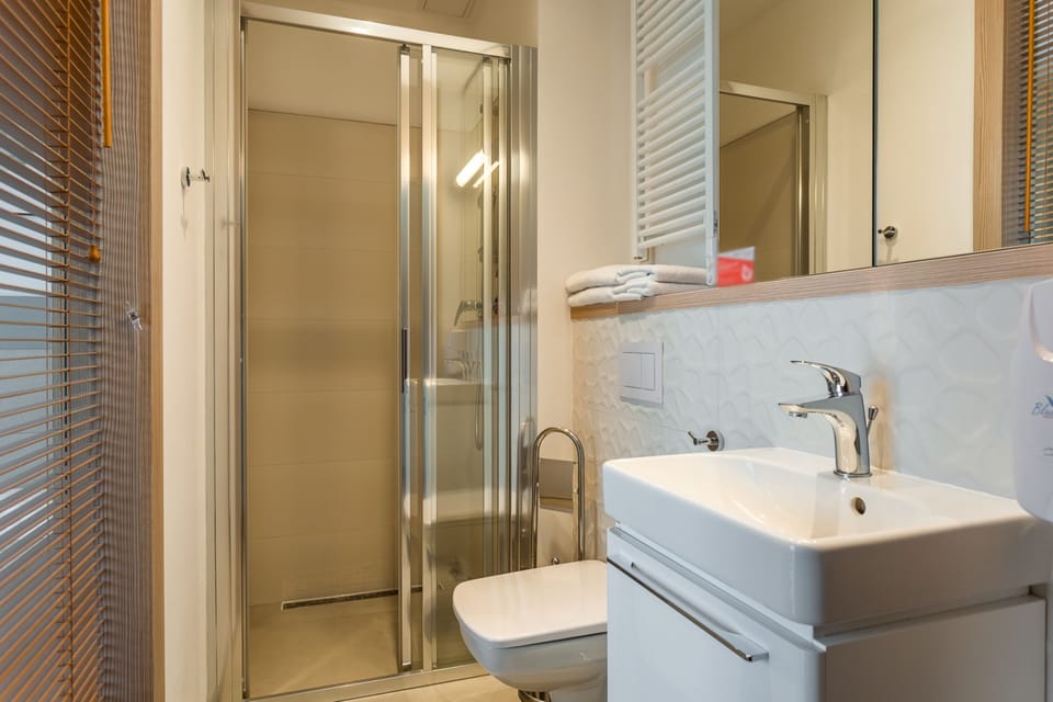 Economy Studio | Bathroom | Hair dryer, towels, soap, shampoo