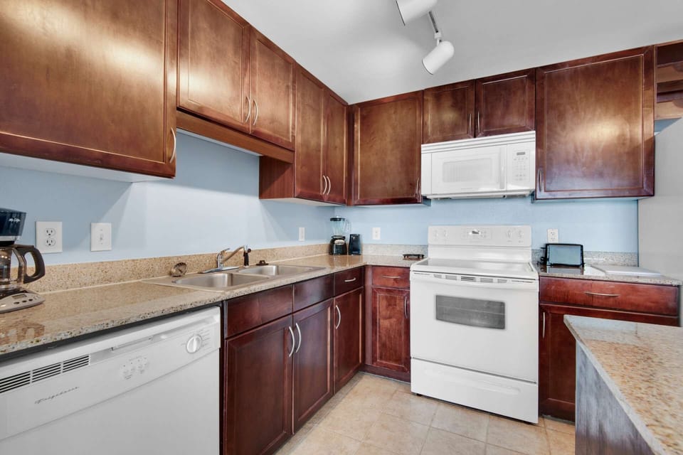 Fully equipped kitchen lets you prep a meal while visiting with friends and family in the living room and viewing the Emerald Coast beyond.