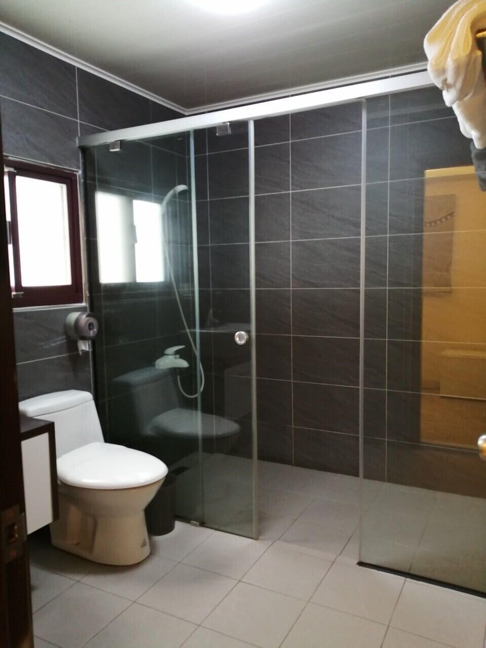 Elite Quadruple Room, 2 Double Beds | Bathroom | Shower, rainfall showerhead, slippers, towels