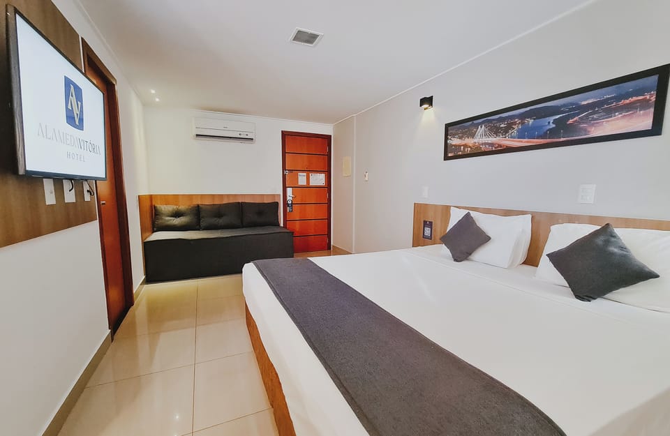 Deluxe Triple Room | Minibar, in-room safe, laptop workspace, blackout drapes