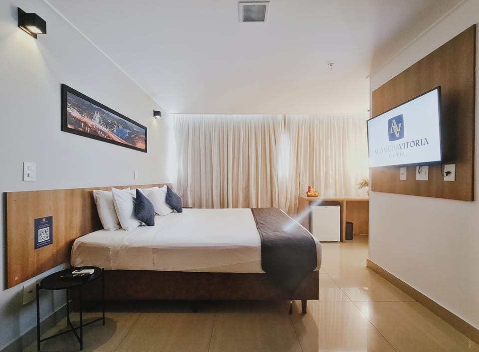 Deluxe Triple Room | Minibar, in-room safe, laptop workspace, blackout drapes