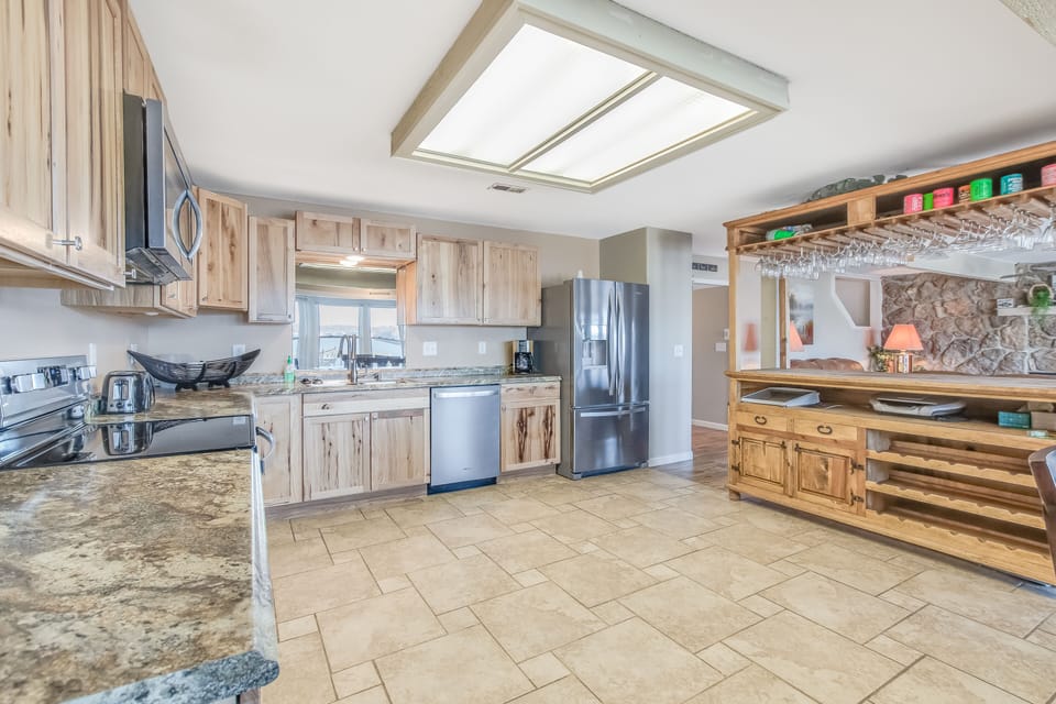 Kitchen located on lower level with plenty of cabinets.  