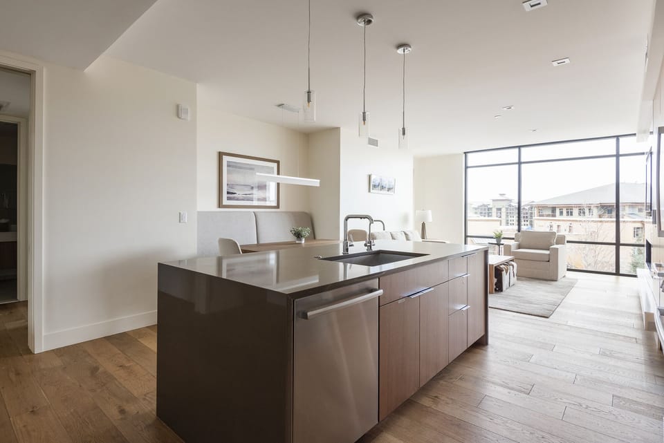 Kitchen island looking over the dining area and living room, 3 drop pendant lights over the kitchen island