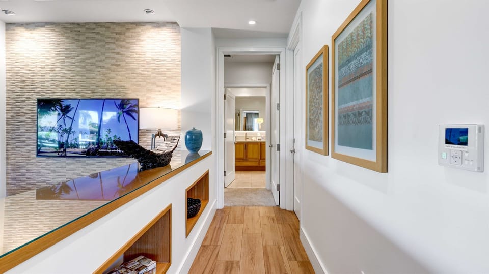 Make your way through the open hallway to the first primary bed & bath