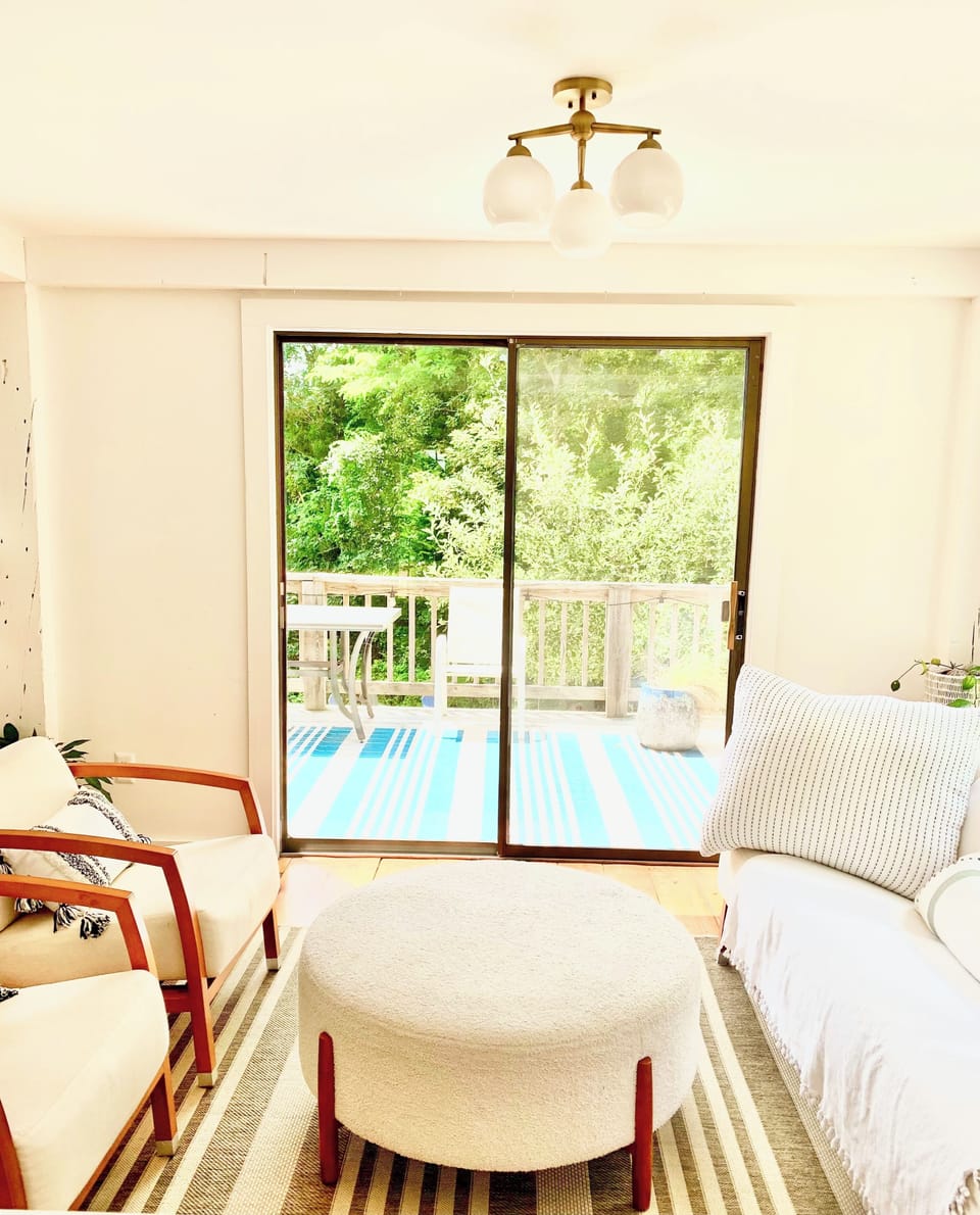 Living room area with access to outdoor deck.