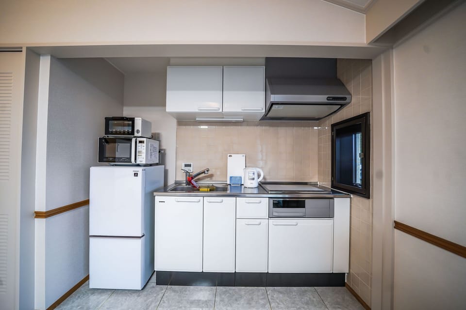 Annex Condominium | Private kitchen | Fridge, electric kettle