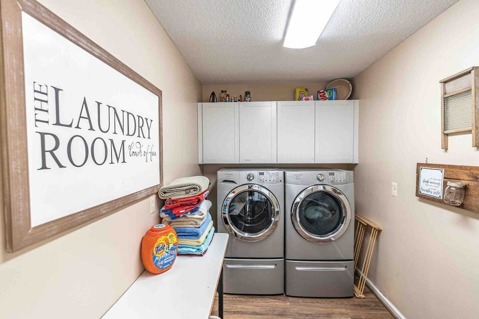 Full laundry room includes washer, dryer, and complimentary laundry soap.