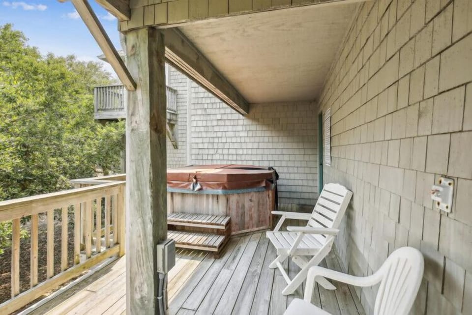 Soak in your private hot tub while surrounded by lush treetops—your perfect spot to unwind after a day of exploring.