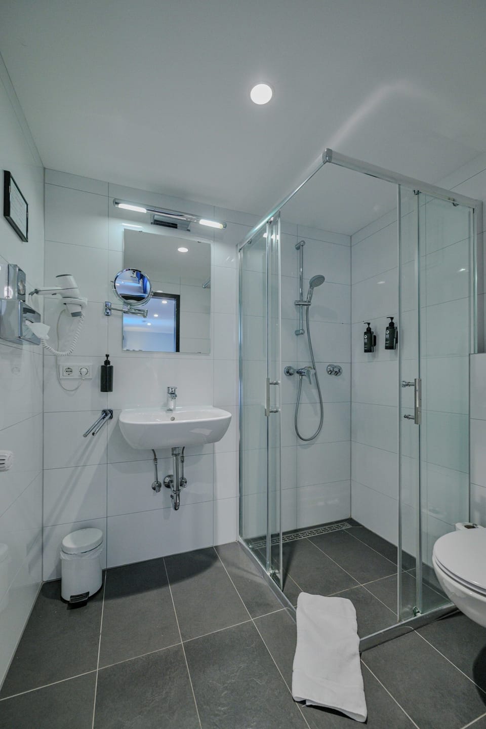 Shower, hair dryer, slippers, towels