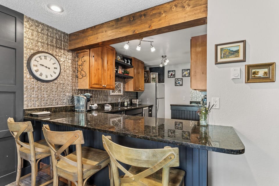 Kitchen and bar with granite counters