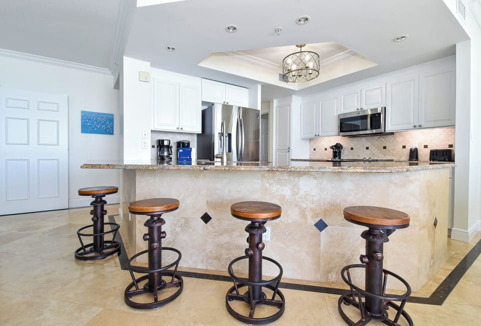 Your gourmet kitchen awaits with granite countertops, stainless appliances, and breakfast bar seating perfect for morning coffee or evening cocktails.