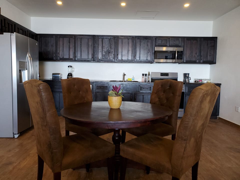 1 of 3 fully equipped kitchens with a dining area.