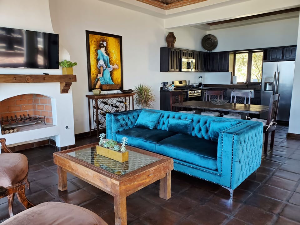 Stylish ocean-view living room, tastefully decorated with a cozy fireplace.