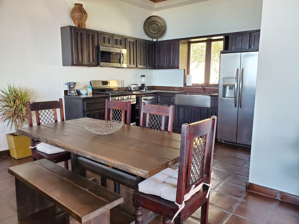 Full-service kitchen equipped with premium, modern appliances and ocean views.