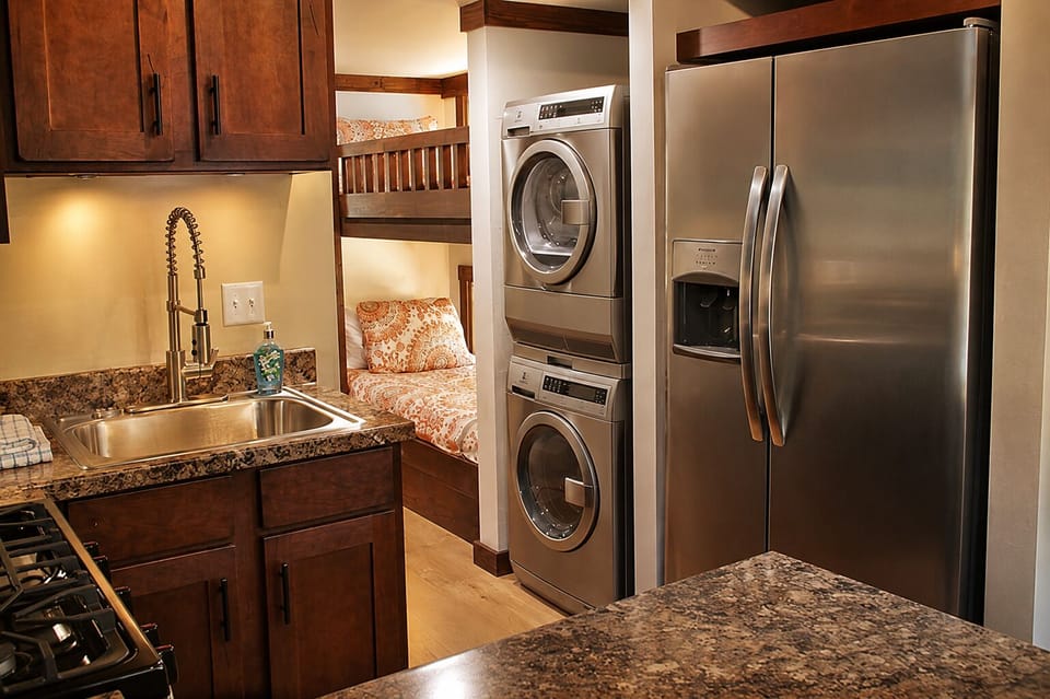 Kitchen Stocked With Towels, Coffee Machine, Dishes, and Soap