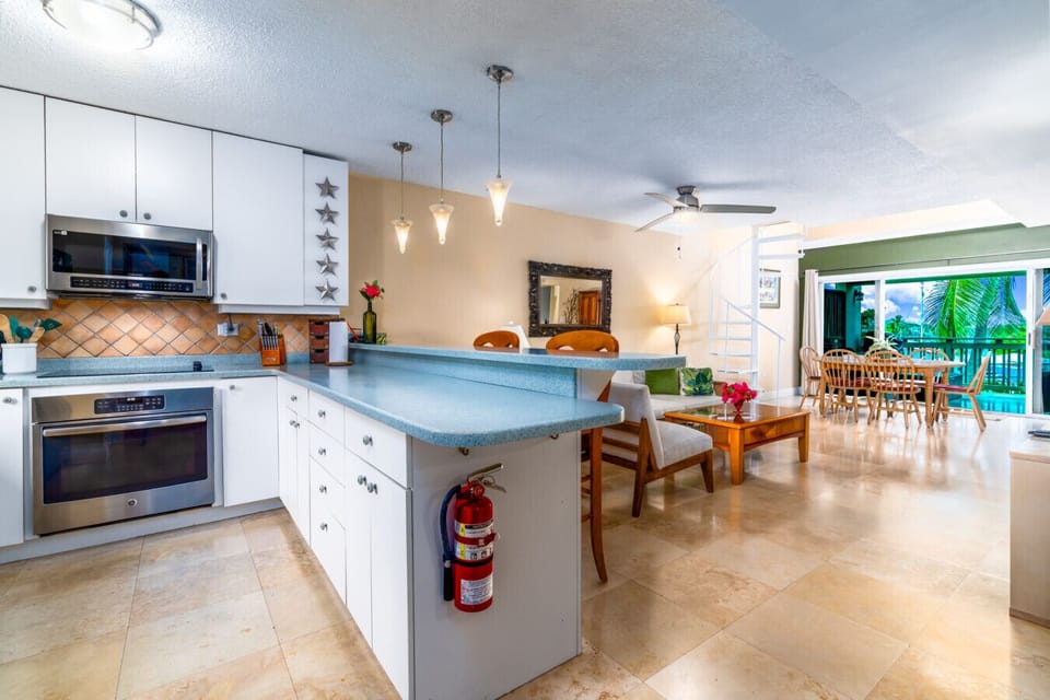 The spacious kitchen with the living room and dining area in the background - as seen from the main entry.