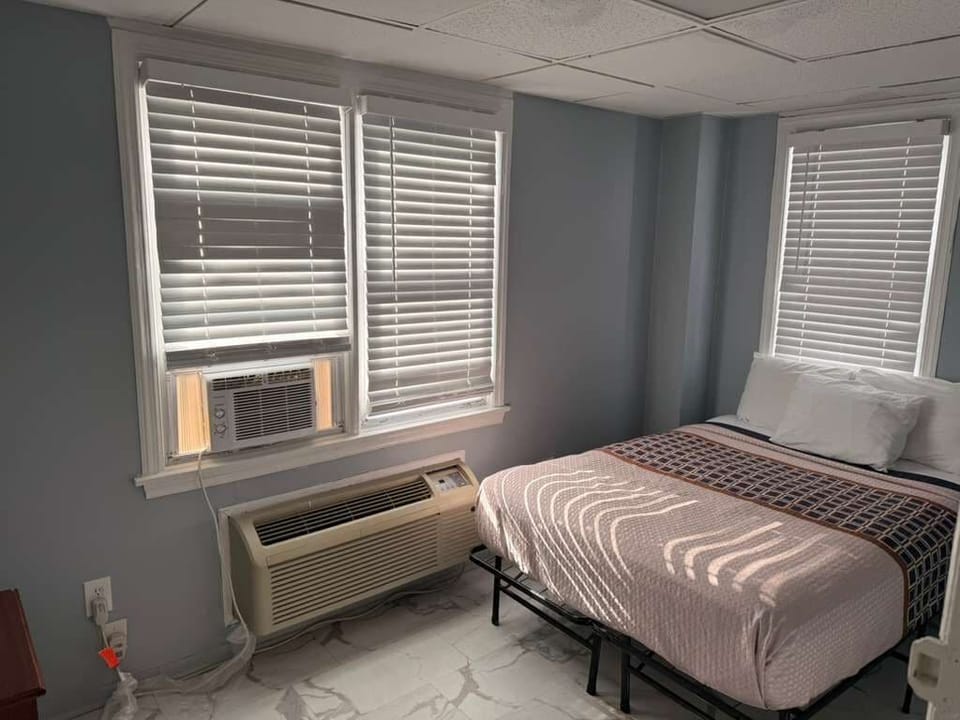 Premium bedding, desk, laptop workspace, blackout drapes