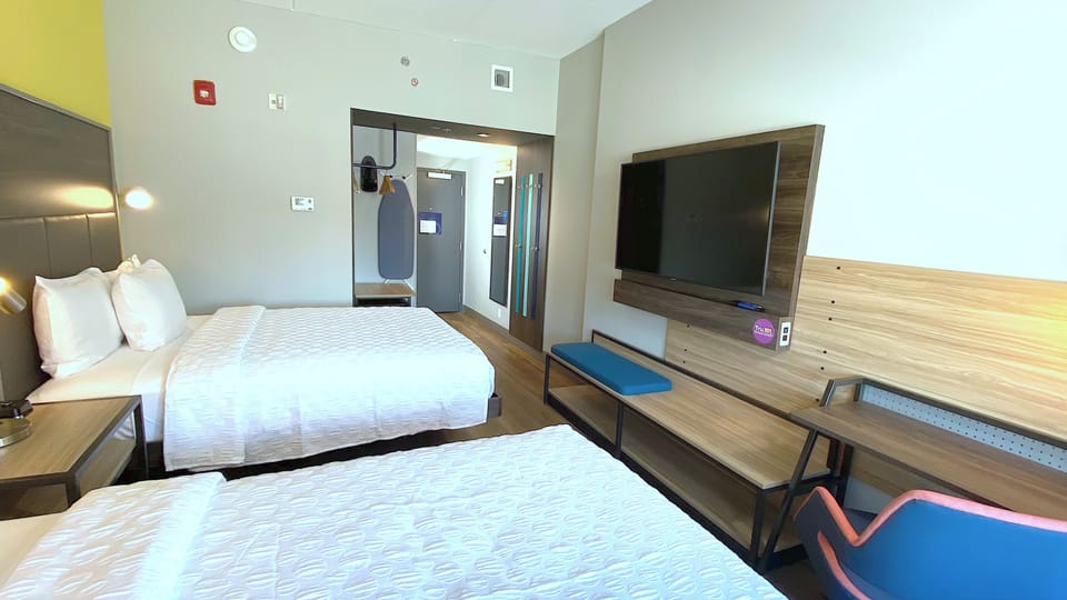 Hypo-allergenic bedding, desk, laptop workspace, blackout drapes