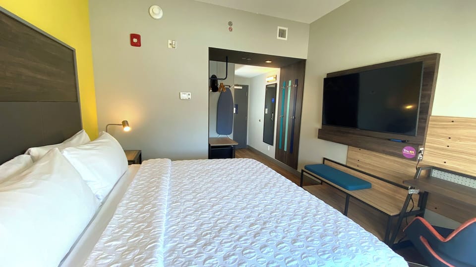 Hypo-allergenic bedding, desk, laptop workspace, blackout drapes