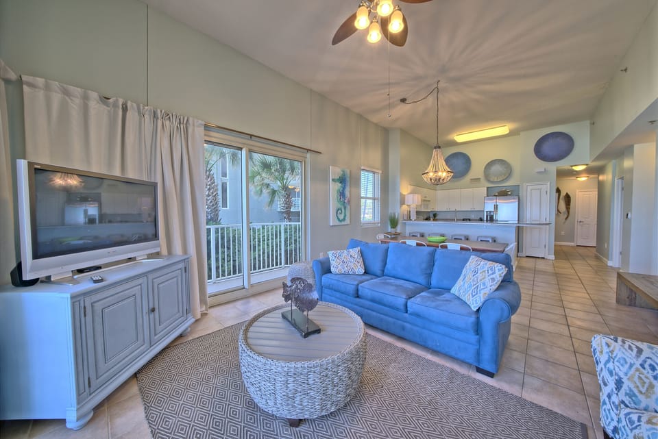 The heart of the condo. The spacious living area flows seamlessly into the kitchen and dining spaces, making it easy for everyone to stay together while still having plenty of room to spread out and relax.